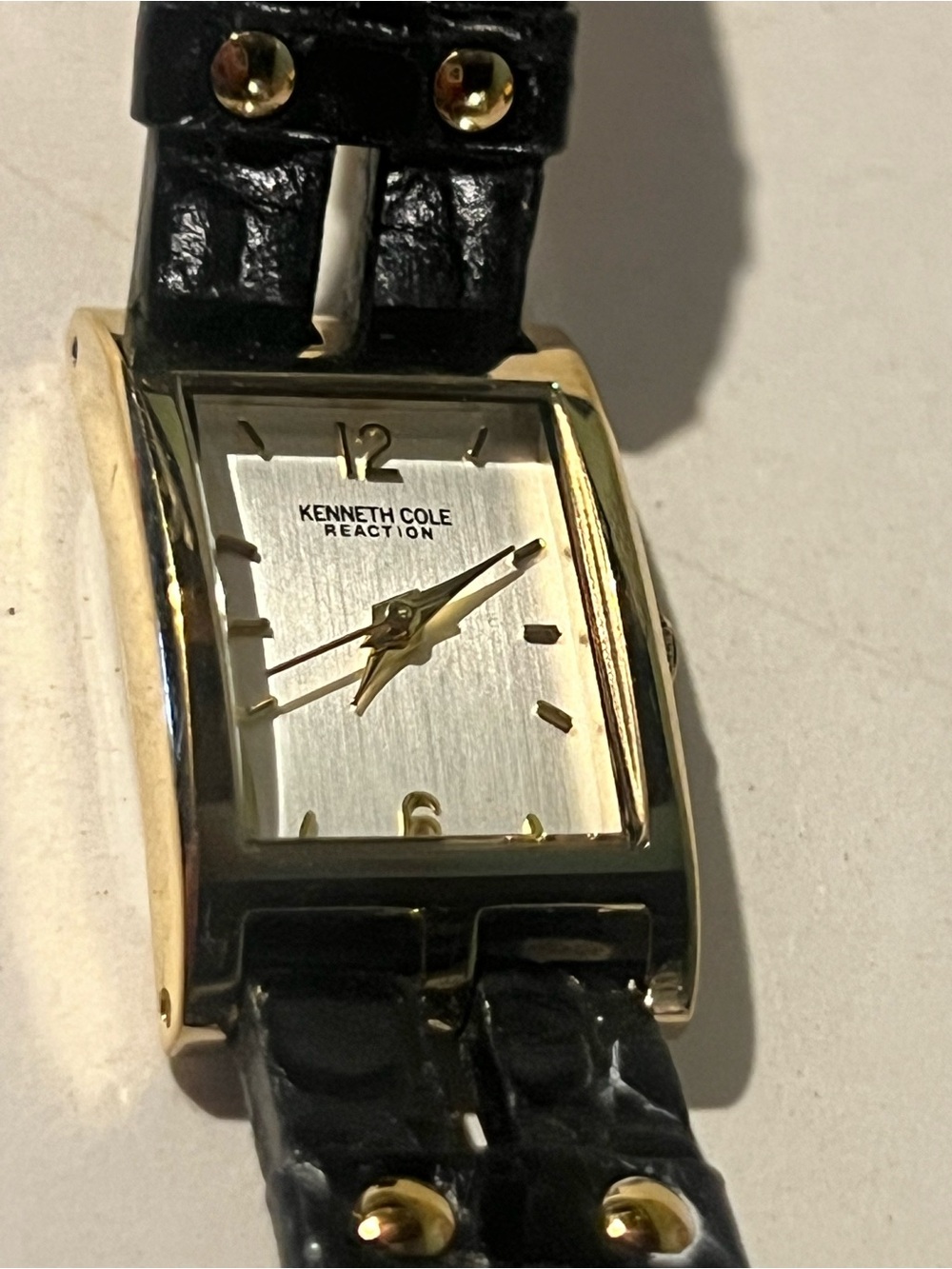 Kenneth Cole Reaction Gold-Tone Rectangular Watch with Black Strap.